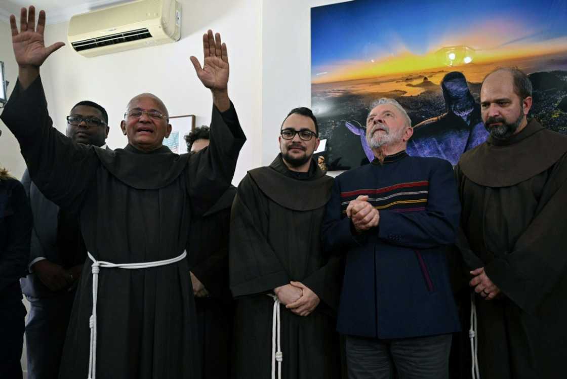 Fray Davi gives his blessing next to (L to R) Fray Gabriel, Brazilian former President (2003-2010) and candidate for the leftist Workers Party (PT) Luiz Inacio Lula da Silva, and Fray Paulo during a meeting to commemorate St. Francis of Assisi day, at the campaign headquarters in Sao Paulo, on October 4, 2022. Fray Davi gives his blessing next to (L to R) Fray Gabriel, Brazilian former President (2003-2010) and candidate for the leftist Workers Party (PT) Luiz Inacio Lula da Silva, and Fray Paulo during a meeting to commemorate St. Francis of Assisi day, at the campaign headquarters in Sao Paulo, on October 4, 2022.