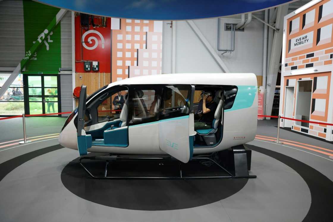 Brazil's Embraer and its subsidiary Eve Air Mobility say they will begin manufacturing electric flying taxis, a model cabin of which is seen here at a Paris air show in June 2023, at a factory near Sao Paolo as early as 2026 Brazil's Embraer and its subsidiary Eve Air Mobility say they will begin manufacturing electric flying taxis, a model cabin of which is seen here at a Paris air show in June 2023, at a factory near Sao Paolo as early as 2026