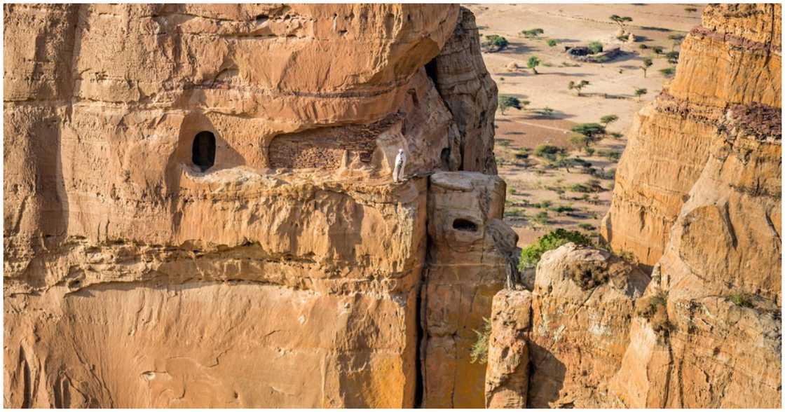 Someone stands near the entrance of the church Someone stands near the entrance of the church
