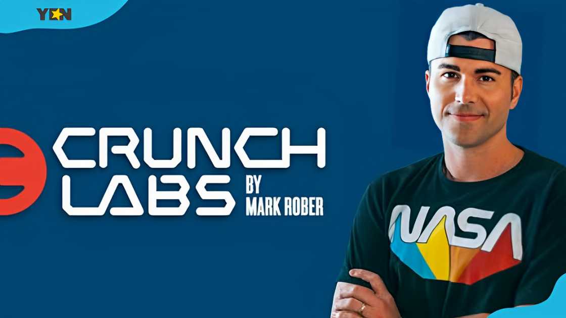 Mark Rober stands alongside the logo for his company