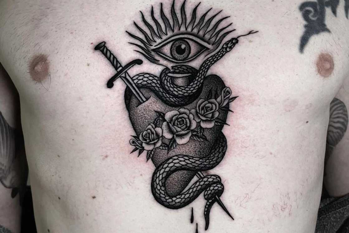 Chest sacred heart and snake tattoo