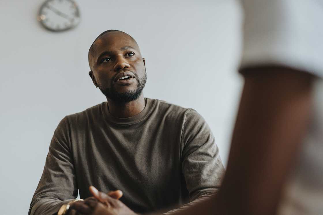 A male school counselor is advising a student A male school counselor is advising a student