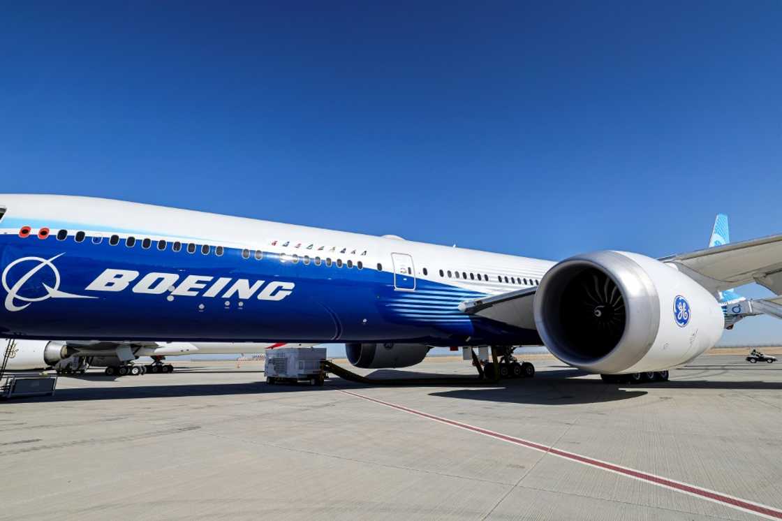 This picture taken on November 13, 2023 shows a view of the fuselage and one of the engines of a Boeing 777-9 jetliner aircraft on the tarmac during the 2023 Dubai Airshow at Dubai World Central - Al-Maktoum International Airport in Dubai.