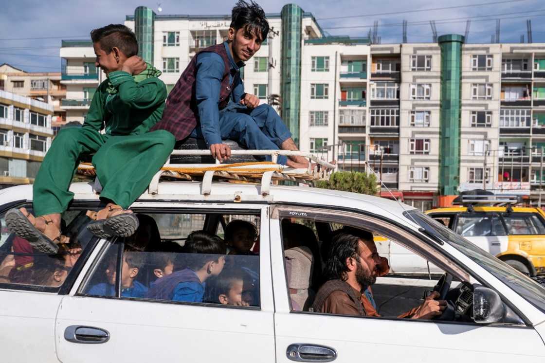 Sprawling families cram into the Corolla, with passengers far outnumbering seats