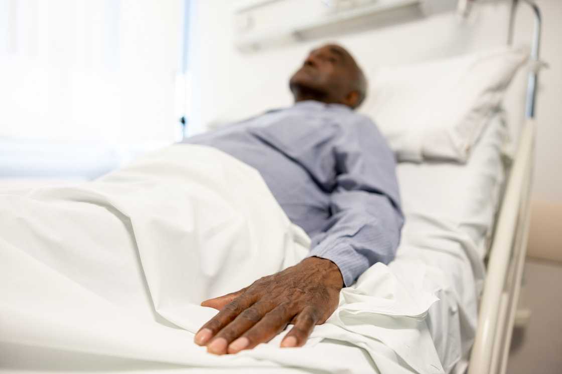 A man lying in a hospital bed A man lying in a hospital bed