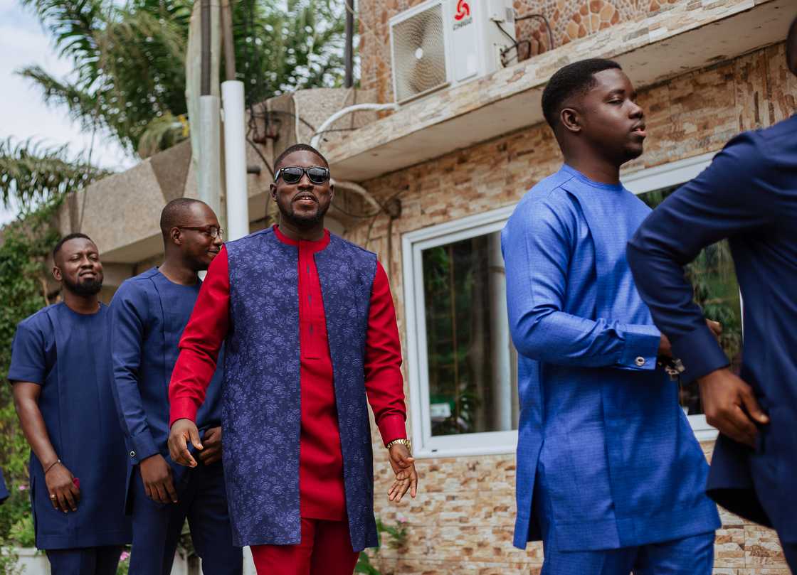 A group of friends and family dancing on a street.