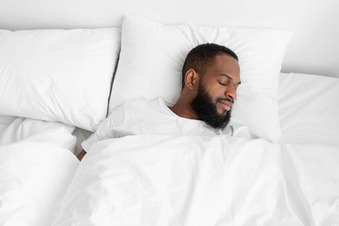 Calm and peaceful bearded man sleeping on bed Calm and peaceful bearded man sleeping on bed
