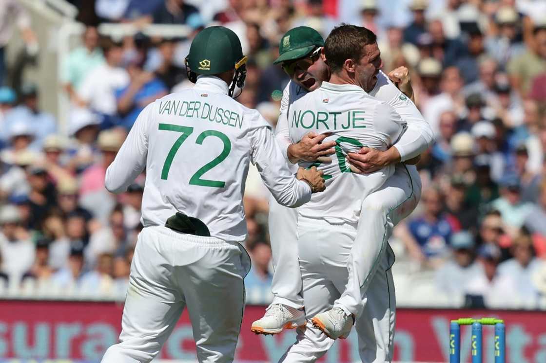 All together - South Africa's Anrich Nortje (R) celebrates with skipper Dean Elgar (C) after dismissing England's Alex Lees in the first Test at Lord's All together - South Africa's Anrich Nortje (R) celebrates with skipper Dean Elgar (C) after dismissing England's Alex Lees in the first Test at Lord's