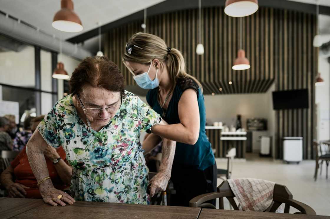 A volunteer attends to Alzheimer's patients at a center in Dax, southwestern France A volunteer attends to Alzheimer's patients at a center in Dax, southwestern France
