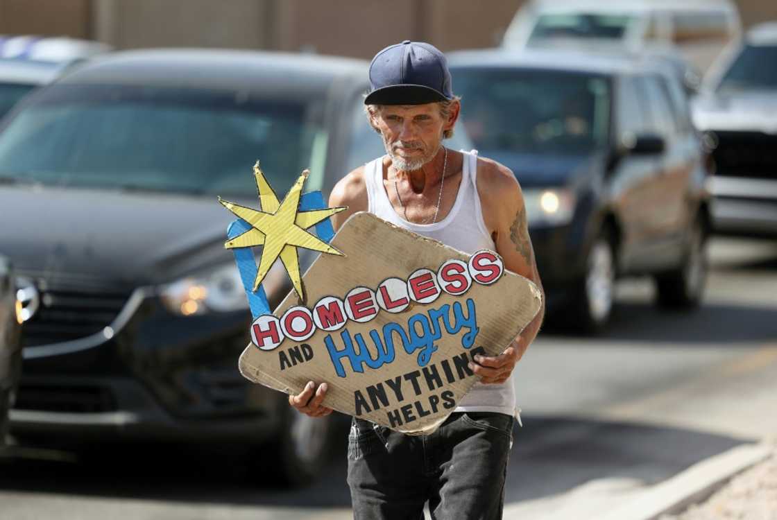 Sam Mitchell, an electrician who lost his job four years ago, panhandles at traffic lights