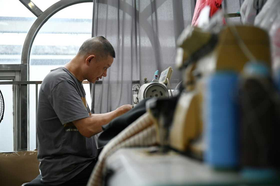 A worker sews clothing at the workshop of Amanda Yao, who is fighting to promote confidence in plus-size women A worker sews clothing at the workshop of Amanda Yao, who is fighting to promote confidence in plus-size women
