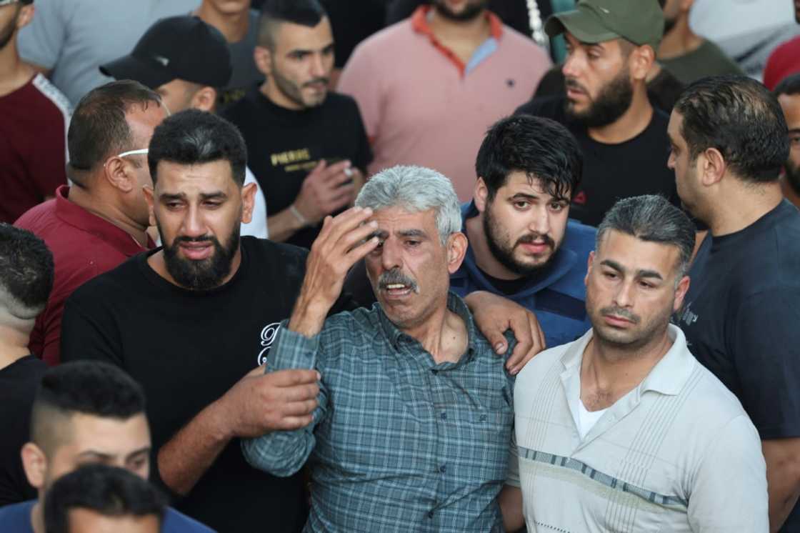 Mourners outside a hospital in Nablus on Sunday morning Mourners outside a hospital in Nablus on Sunday morning