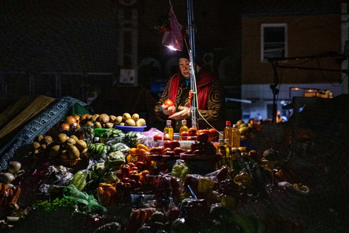 A vendor waits for customers during a power cut at Bessarabsky market in Kyiv A vendor waits for customers during a power cut at Bessarabsky market in Kyiv