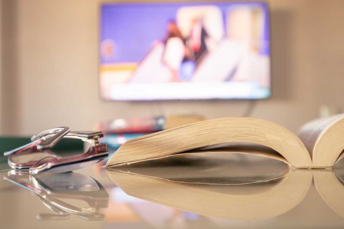 A cosy living room with with a TV and an open novel. A cosy living room with with a TV and an open novel.