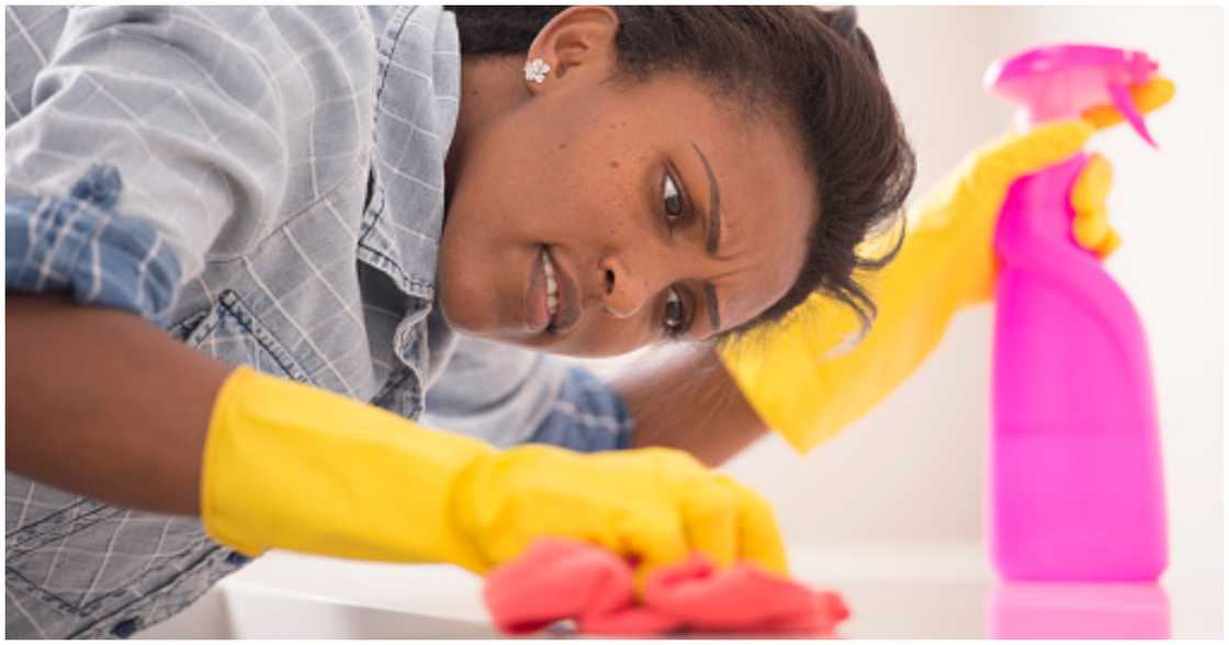 A woman cleaning her home