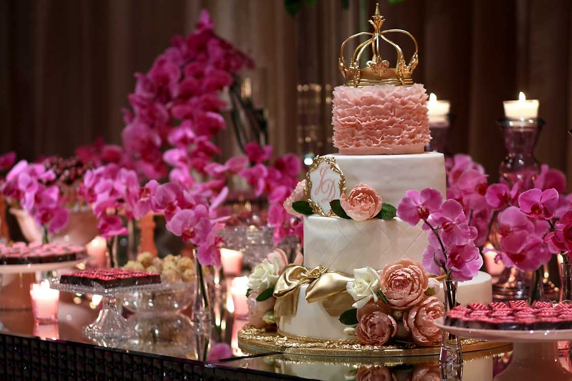 A three tier pink and gold cake