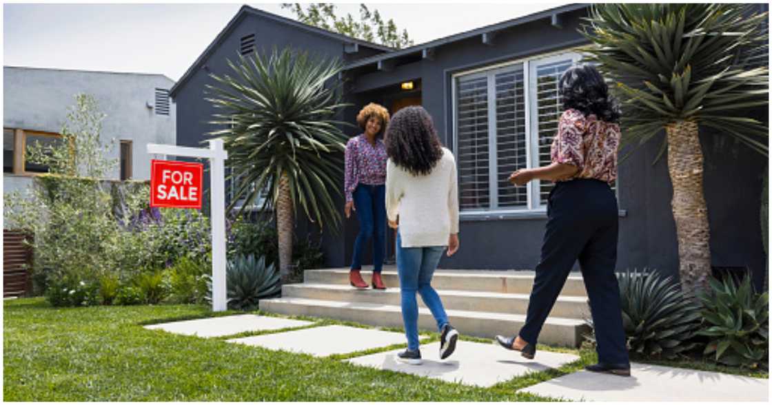 Two people meet with a property owner for a potential sale