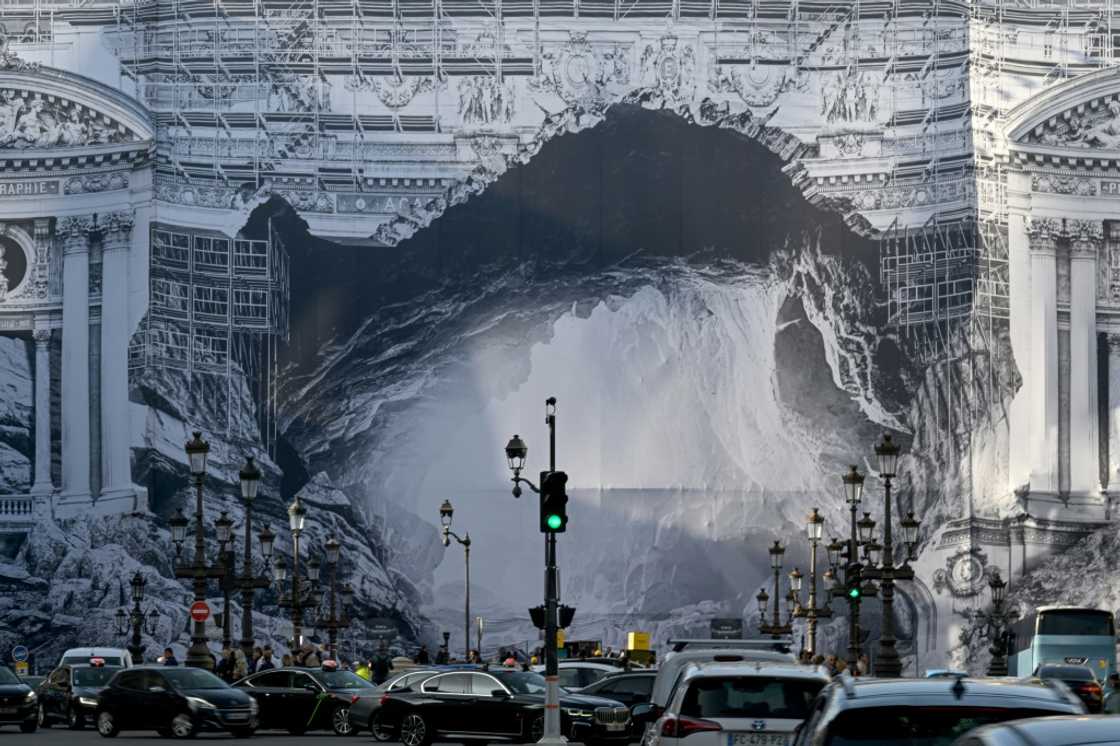 An installation by French artist JR, depicting the philosophical allegory of Plato's cave, covers part of the facade of the Opera Garnier during renovation An installation by French artist JR, depicting the philosophical allegory of Plato's cave, covers part of the facade of the Opera Garnier during renovation