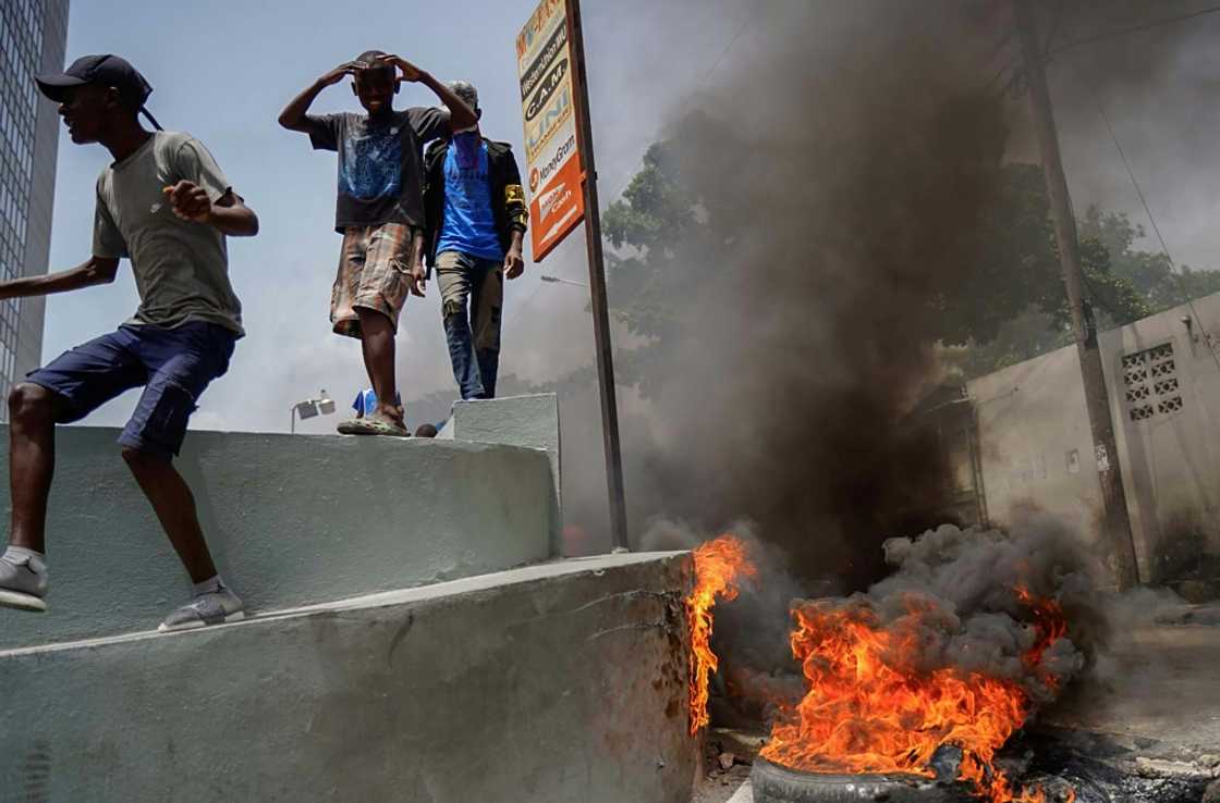 Haitians protesting high prices and shortages burn tires on a street of Port-au-Prince on July 13, 2022 Haitians protesting high prices and shortages burn tires on a street of Port-au-Prince on July 13, 2022