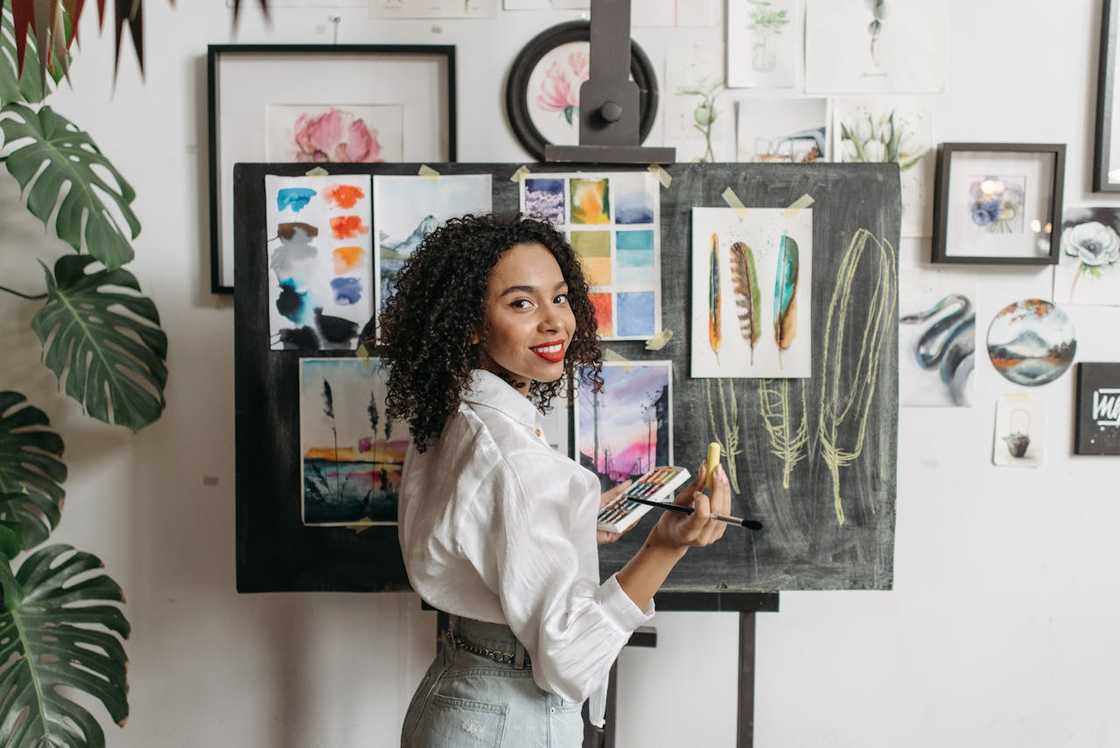 A woman painting in a small art studio.