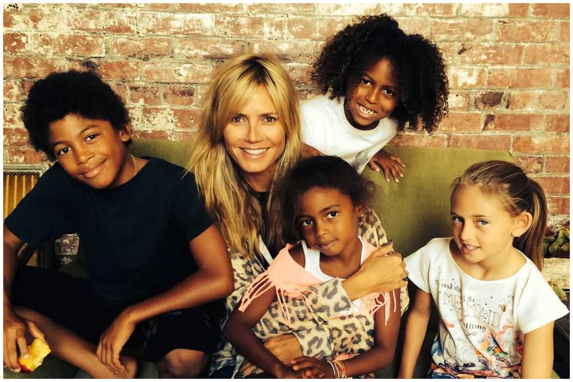 Heidi and her children, Henry, Leni, Lou, and Johan, resting indoors.