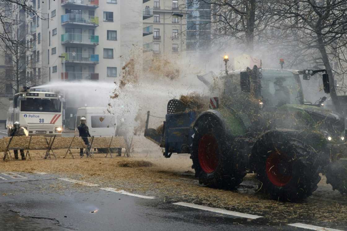 A tractor discharged hay onto riot police in Brussels A tractor discharged hay onto riot police in Brussels