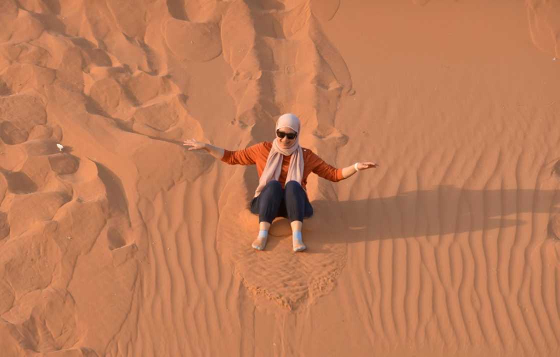 A woman surfs down a sand dune in the "Saed" desert area, 110 kilometres east of Riyadh A woman surfs down a sand dune in the "Saed" desert area, 110 kilometres east of Riyadh