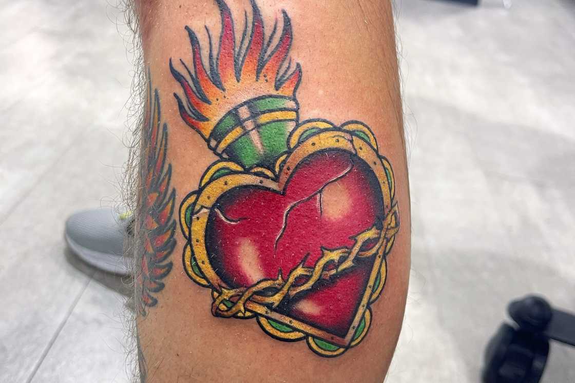 Leg neo-traditional sacred heart tattoo