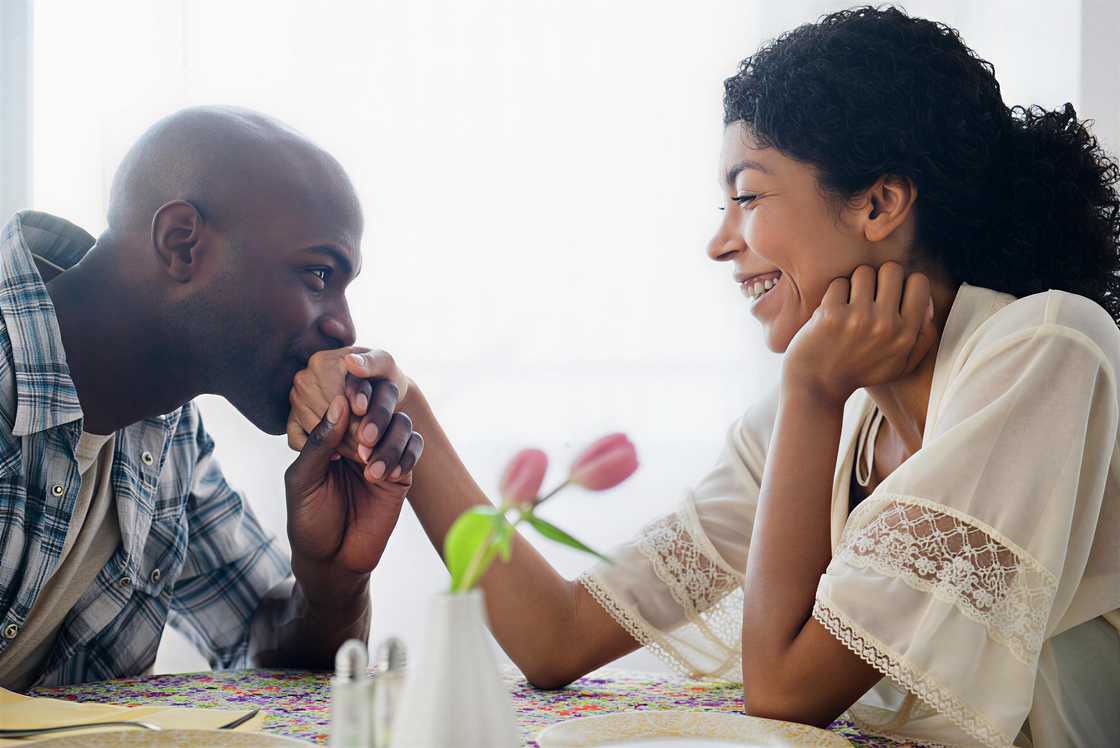 Man kissing a hand of a girl Man kissing a hand of a girl