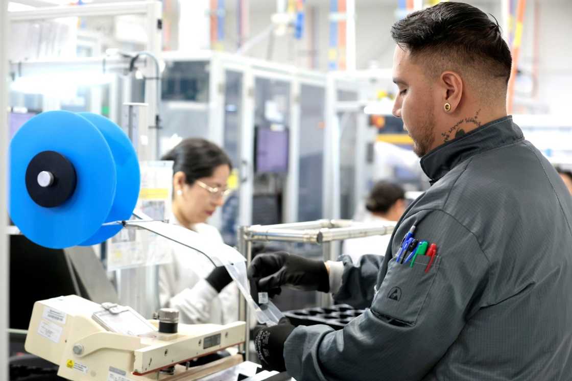 Workers assemble electronic car keys at a manufacturing plant in Mexico Workers assemble electronic car keys at a manufacturing plant in Mexico