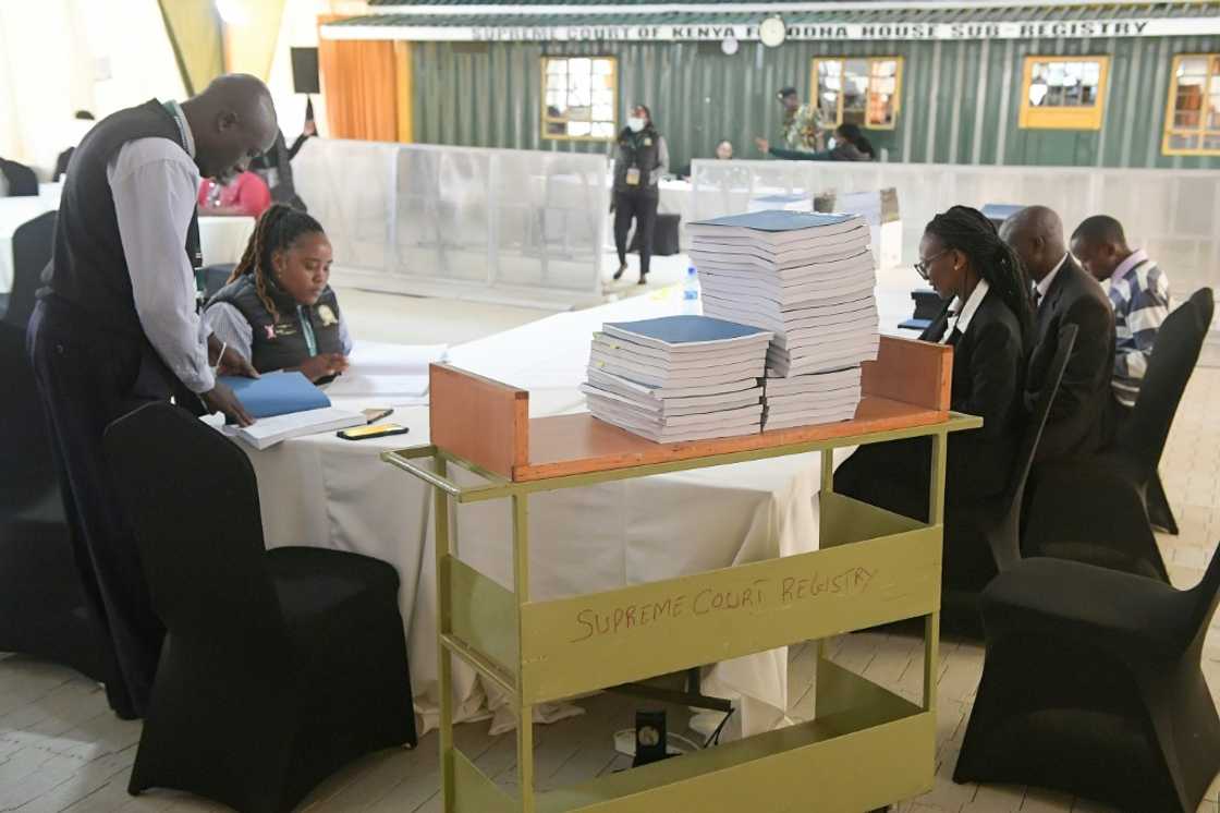 Kenyan court officials in Nairobi verify documents filed by presidential candidate Raila Odinga challenging the result of the August 9, 2022 election that handed victory to his rival William Ruto Kenyan court officials in Nairobi verify documents filed by presidential candidate Raila Odinga challenging the result of the August 9, 2022 election that handed victory to his rival William Ruto