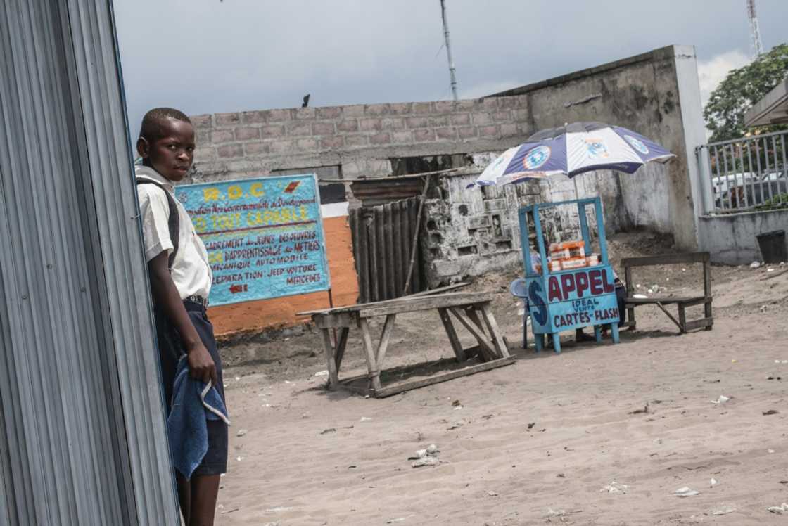 A child stands next to a road stall selling cellular telephone cards and internet access in Kinshasa in 2015 A child stands next to a road stall selling cellular telephone cards and internet access in Kinshasa in 2015