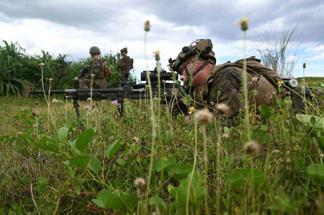 A US marine sniper takes aim during a joint amphibious landing exercise with Philippine counterparts in San Antonio A US marine sniper takes aim during a joint amphibious landing exercise with Philippine counterparts in San Antonio