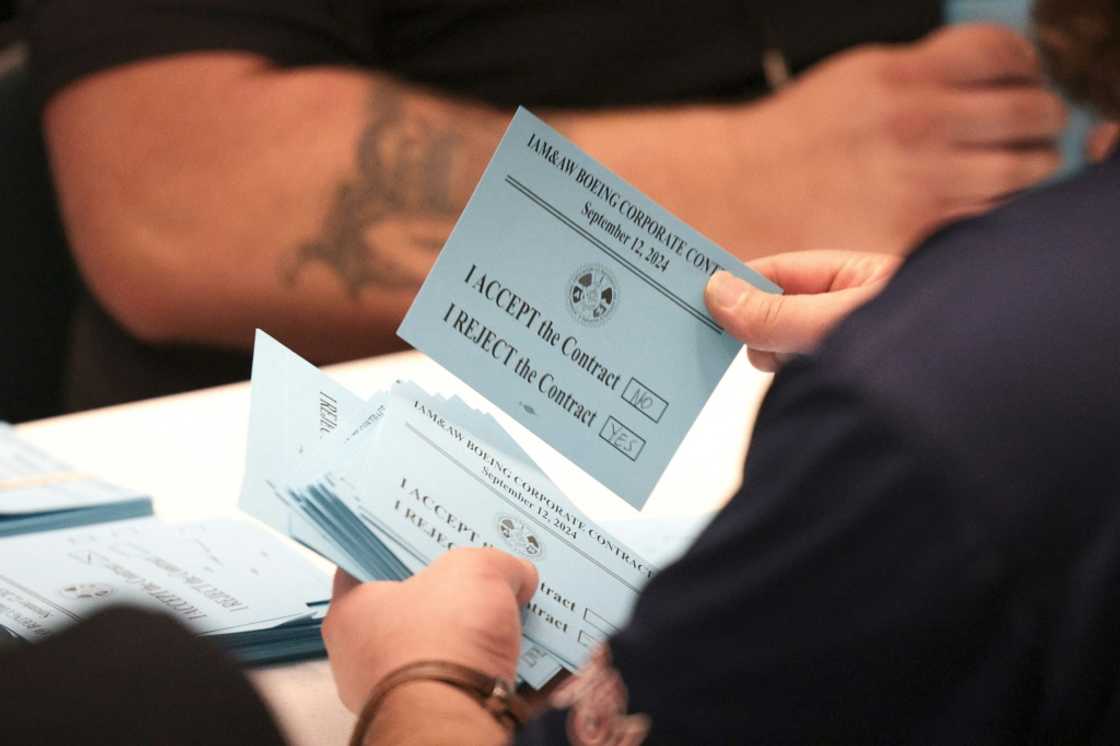 Boeing Machinists union members count votes to accept or reject a proposed contract between Boeing and union leaders and whether or not to strike if the contract is rejected