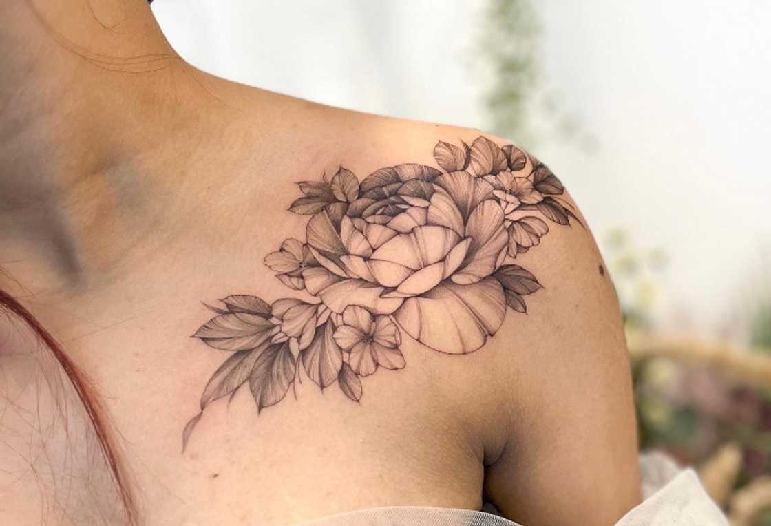 Stunning flower arm and collarbone tattoo