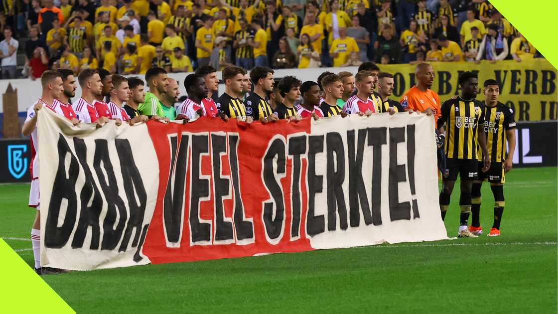 Vitesse and Ajax players hold a banner in support of Tijani Babangida Vitesse and Ajax players hold a banner in support of Tijani Babangida