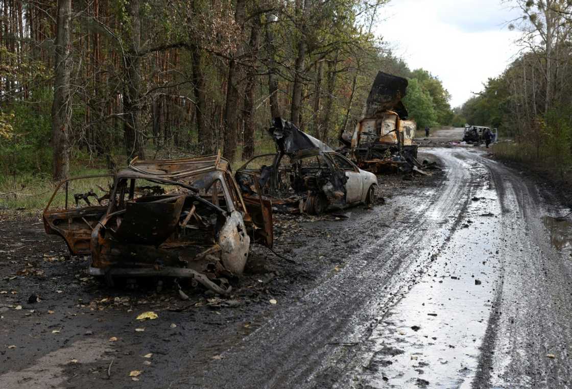 Destroyed civilian vehicles on a road near Izyum, Kharkiv region in eastern Ukraine after the Russian troops left the key town of Lyman Destroyed civilian vehicles on a road near Izyum, Kharkiv region in eastern Ukraine after the Russian troops left the key town of Lyman