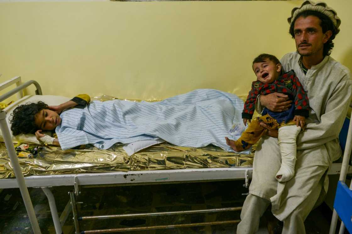 An Afghan man with his injured children at a hospital in Sharan, Paktika province, following the eartrhquake An Afghan man with his injured children at a hospital in Sharan, Paktika province, following the eartrhquake