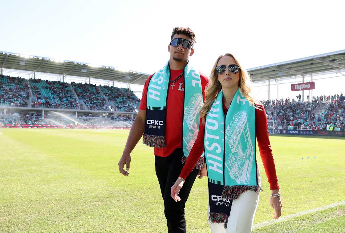 Brittany and Patrick Mahomes walk on the field before the match