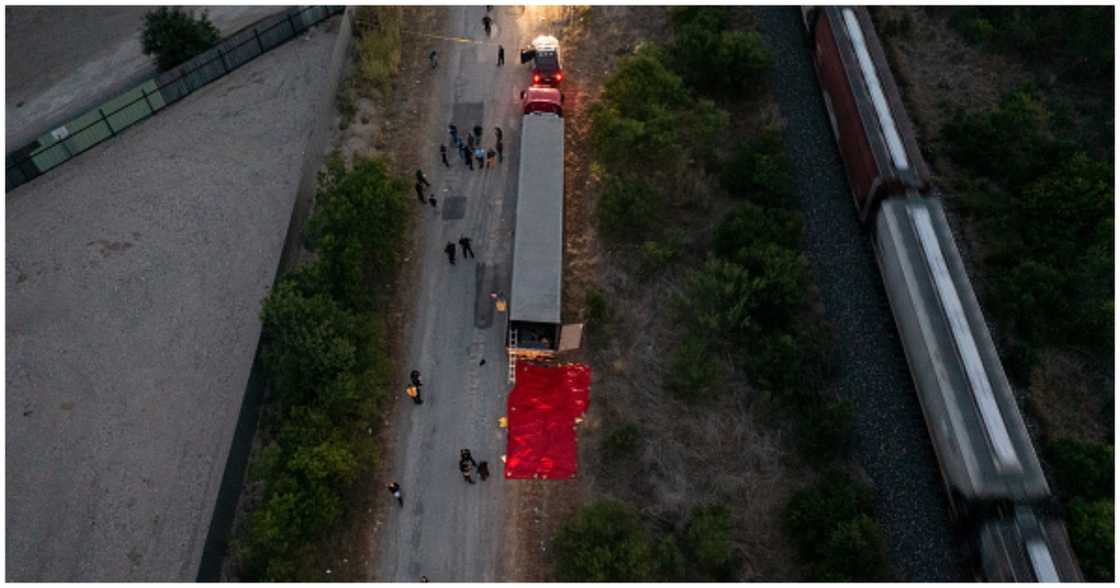 members of law enforcement investigate a tractor trailer on June 27, 2022 in San Antonio, Texas.