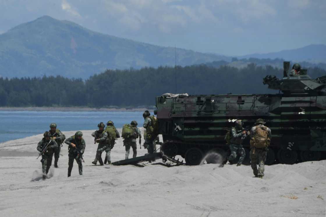 Philippine and US marines disembark from amphibious assault vehicles during a joint landing exercise at a beach Philippine and US marines disembark from amphibious assault vehicles during a joint landing exercise at a beach