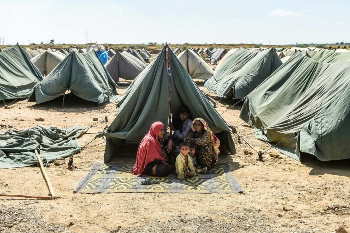 Families displaced by recent flooding live in row upon row of simple A-frame tents