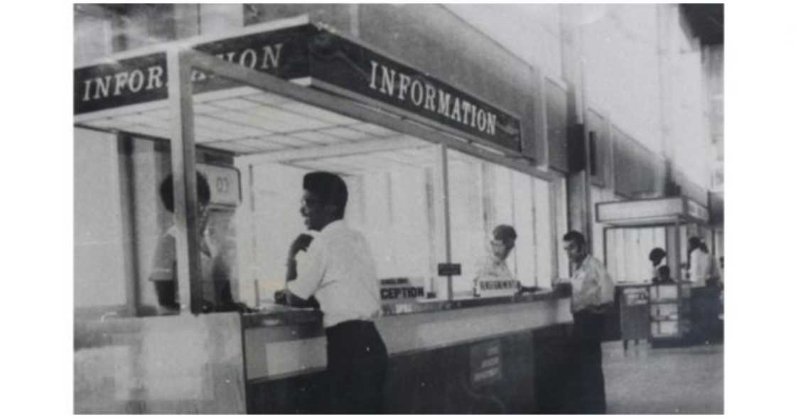 People at a counter in the airport