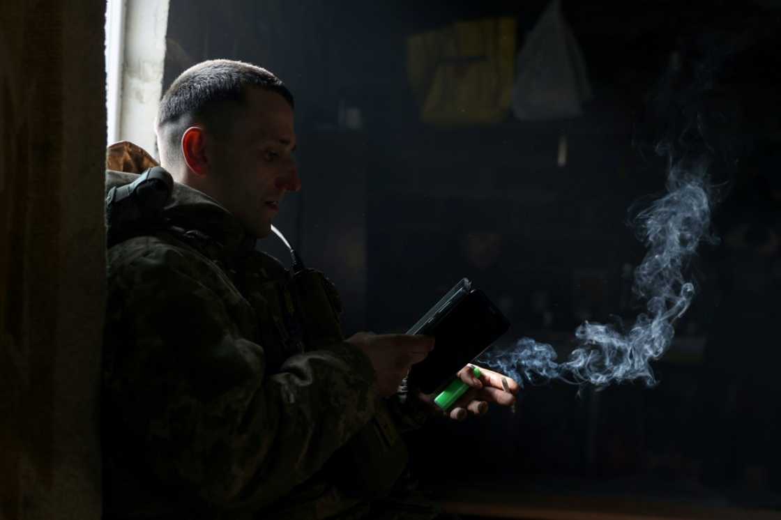A Ukrainian soldier smokes a cigarette as he rests at a frontline in the Donetsk region