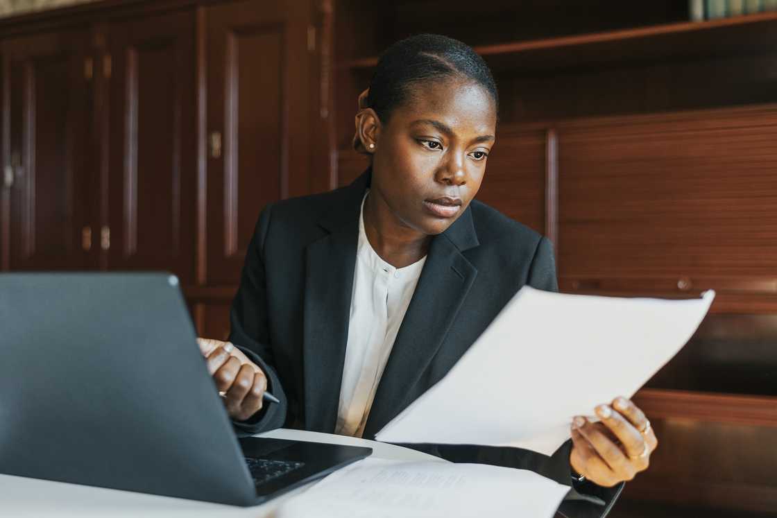 A lady compares her reports