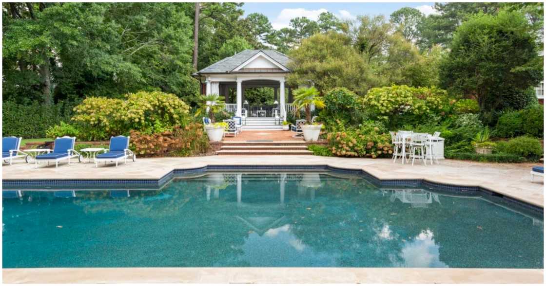 The mansion has a pool and pool house