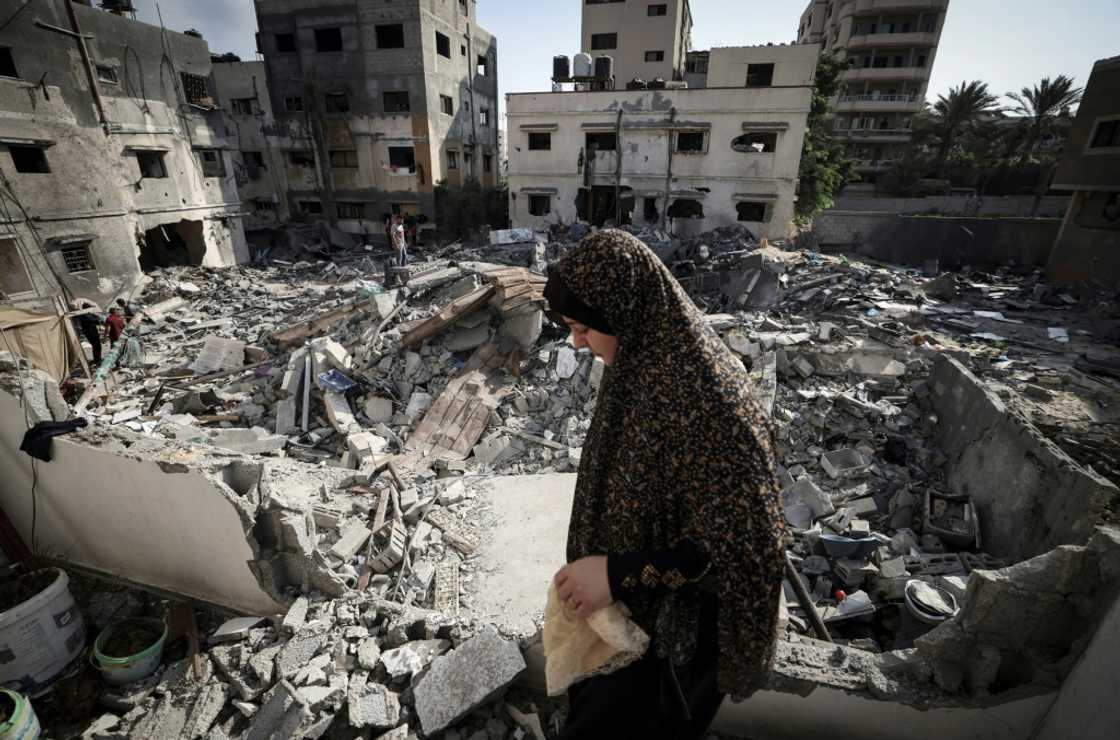 A Palestinian woman surveys the rubble of her home in Gaza City after a ceasefire halted three days of Israeli air strikes and retaliatory rocket fire by militants A Palestinian woman surveys the rubble of her home in Gaza City after a ceasefire halted three days of Israeli air strikes and retaliatory rocket fire by militants