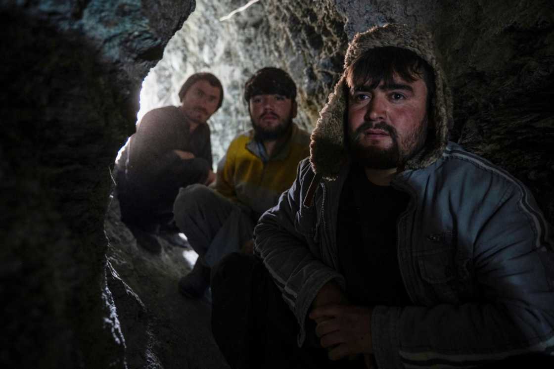 Afghan miners sit near the entrance of a gold mine tunnel in the mountains of Badakhshan province's Yaftal Sufla district Afghan miners sit near the entrance of a gold mine tunnel in the mountains of Badakhshan province's Yaftal Sufla district
