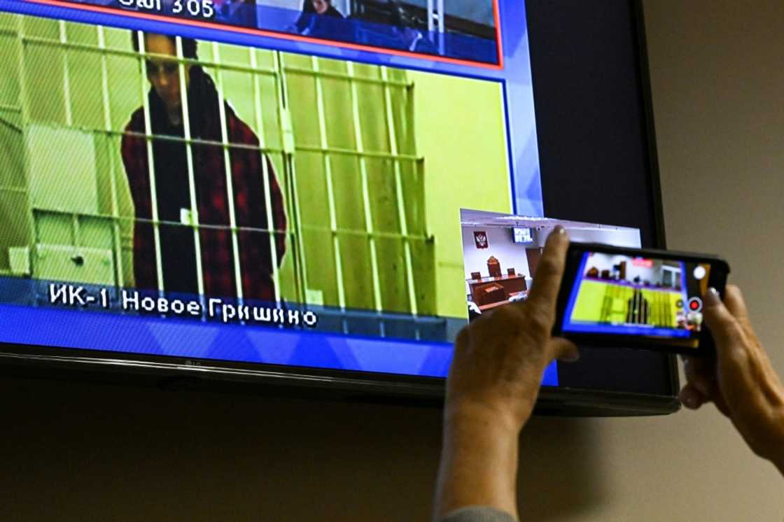 US basketball player Brittney Griner, who was sentenced to nine years in a Russian penal colony for drug smuggling, is seen on a screen via a video link during a court hearing at the Moscow regional court October 25, 2022 US basketball player Brittney Griner, who was sentenced to nine years in a Russian penal colony for drug smuggling, is seen on a screen via a video link during a court hearing at the Moscow regional court October 25, 2022