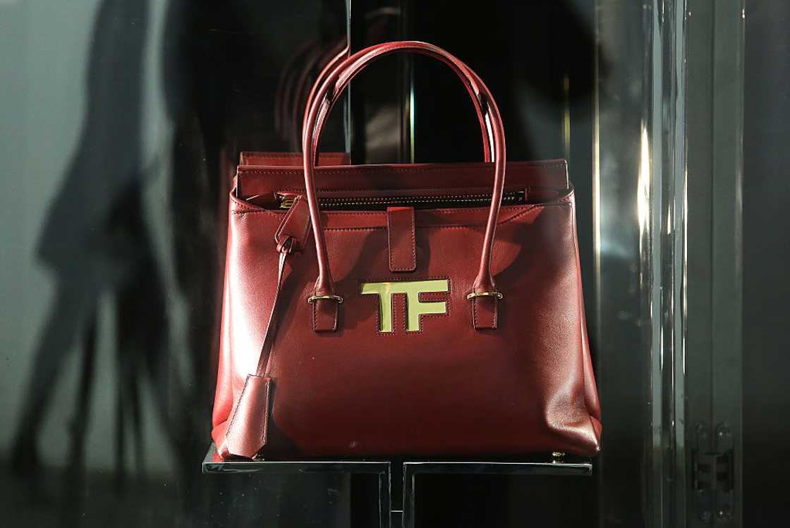 A stylish Tom Ford icon handbag in brown leather with gold hardware.
